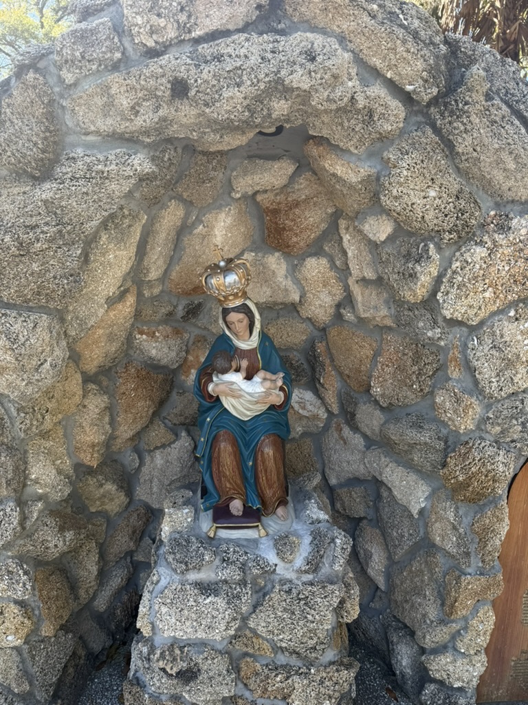 The crowned statue of Our Lady of La Leche nursing the infant Jesus in the coquina grotto